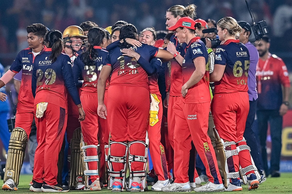 Royal Challengers Bengaluru's players celebrate after winning the Women's Premier League (WPL) Twenty20 final cricket match against Delhi Capitals at the Kotambi Stadium in Vadodara on February 5, 2026.