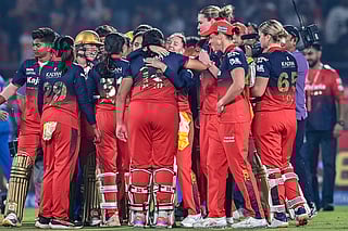 Royal Challengers Bengaluru's players celebrate after winning the Women's Premier League (WPL) Twenty20 final cricket match against Delhi Capitals at the Kotambi Stadium in Vadodara on February 5, 2026.