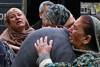 People mourn the death of their relatives following a suicide bombing at a mosque, outside a hospital in Islamabad on February 6, 2026.