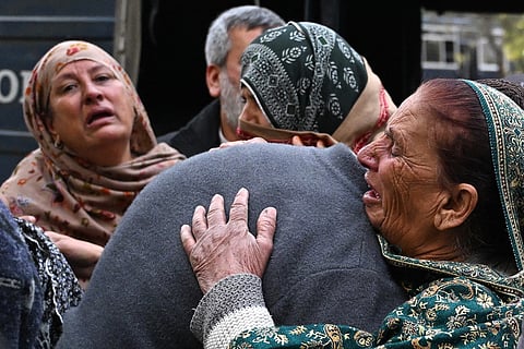 People mourn the death of their relatives following a suicide bombing at a mosque, outside a hospital in Islamabad on February 6, 2026.