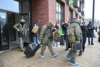 Investigators leave a high-rise residential building, the scene of an assassination attempt on Russian Lieutenant General Vladimir Alekseyev, in Moscow on February 6, 2026.