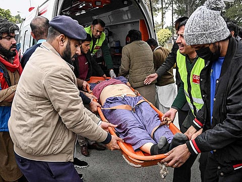 People shift an injured man to a hospital following an explosion at a mosque in Islamabad on February 6, 2026. 