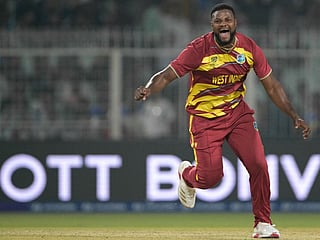 West Indies' Romario Shepherd celebrates after taking the hat-trick wicket during the 2026 ICC Men's T20 Cricket World Cup group stage match against Scotland at the Eden Gardens in Kolkata on February 7, 2026.