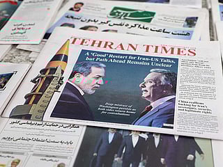 A photograph shows copies of Iranian daily newspapers reporting on the first round of talks between Iran and the United States at a kiosk in Tehran on February 7, 2026. 