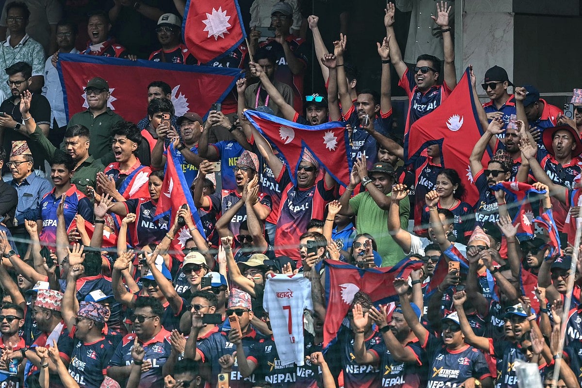 Nepal's fans cheer from the stands during the 2026 ICC Men's T20 Cricket World Cup group stage match between England and Nepal at the Wankhede Stadium in Mumbai on February 8, 2026.