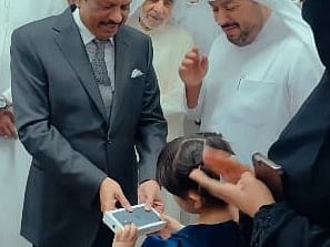 Indian businessman Yusuffali gifts girl iPhone 17 at Kalba Lulu opening
