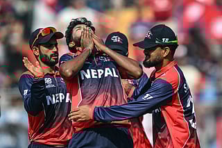Nepal's Nandan Yadav (C) celebrates with teammates after taking the wicket of England's Jos Buttler during the 2026 ICC Men's T20 Cricket World Cup group stage match between England and Nepal at the Wankhede Stadium in Mumbai on February 8, 2026.