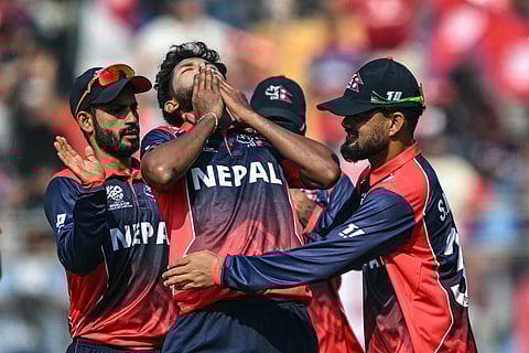 Nepal's Nandan Yadav (C) celebrates with teammates after taking the wicket of England's Jos Buttler during the 2026 ICC Men's T20 Cricket World Cup group stage match between England and Nepal at the Wankhede Stadium in Mumbai on February 8, 2026.