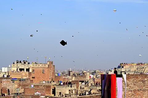 People fly kites during the Basant festival in Lahore on February 8, 2026.