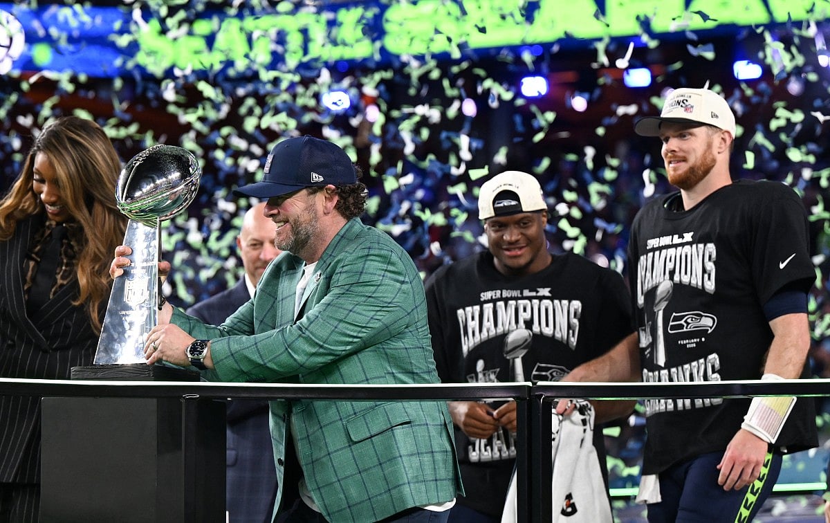 Seattle Seahawks’ quarterback #14 Sam Darnold (R) watches as General Manager John Schneider grabs the Vince Lombardi Trophy after the Seahawks defeated the New England Patriots during Super Bowl LX at Levi's Stadium in Santa Clara, California on February 8, 2026.