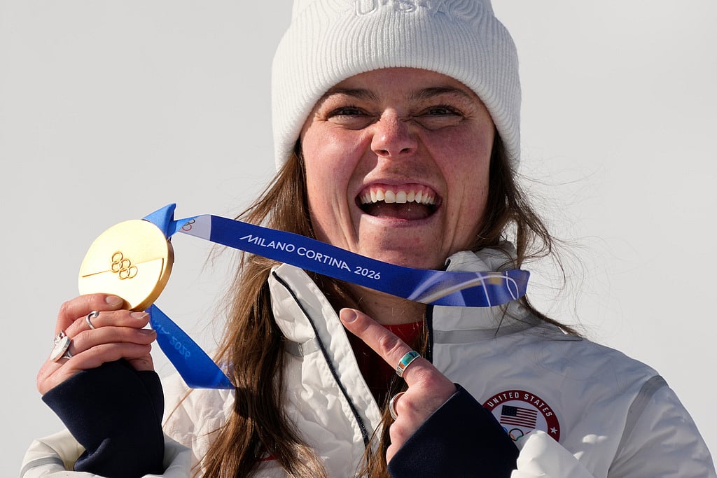 United States' Breezy Johnson shows her gold medal before it breaks 