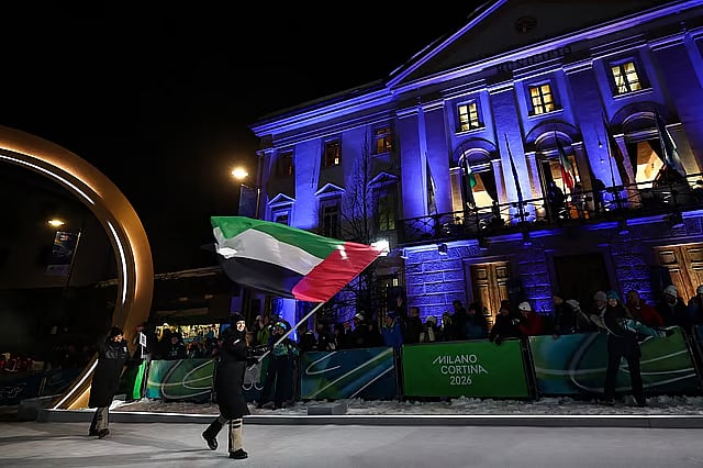 UAE Olympic flag bearer at 2026 Winter Olympic Games at night