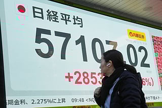 A person walks in front of an electronic stock board showing Japan's Nikkei index at a securities firm Monday, Feb. 9, 2026, in Tokyo. 