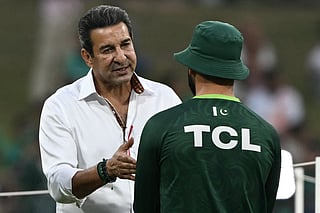 Former Pakistani cricketer Wasim Akram (L) interacts with a Pakistani player before the start of the 2026 ICC Men's T20 Cricket World Cup group stage match between Pakistan and USA at the Sinhalese Sports Club (SSC) Ground in Colombo on February 10, 2026.