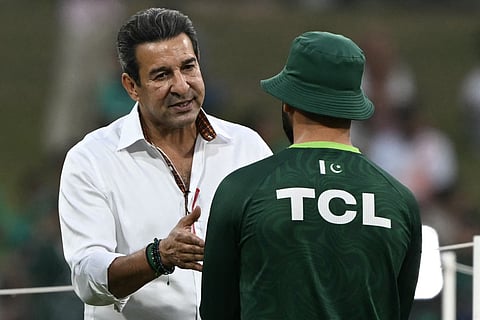 Former Pakistani cricketer Wasim Akram (L) interacts with a Pakistani player before the start of the 2026 ICC Men's T20 Cricket World Cup group stage match between Pakistan and USA at the Sinhalese Sports Club (SSC) Ground in Colombo on February 10, 2026.