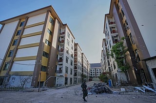 FILE - A Thai soldier keeps guard outside a scam center in O'Smach, Cambodia, Monday, Feb. 2, 2026, 