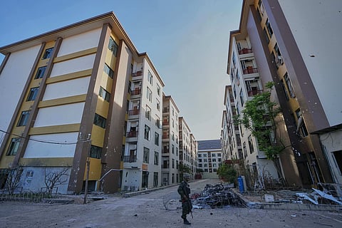 FILE - A Thai soldier keeps guard outside a scam center in O'Smach, Cambodia, Monday, Feb. 2, 2026, 