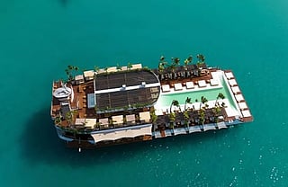 Yona Beach Club, anchored off Phuket’s coast, markets itself as the “world’s first floating beach club.” The venue features multiple decks, bars, a restaurant and an infinity pool overlooking the Andaman Sea, with guests transported by shuttle boats.