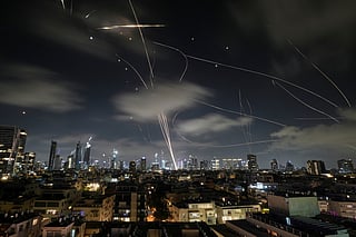 FILE - The Israeli Iron Dome air defense system intercepts missiles during an Iranian attack on Tel Aviv, Israel, June 18, 2025. (AP Photo/Leo Correa, File)