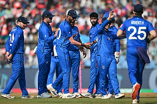 Italy's players celebrate after the dismissal of Nepal's Nandan Yadav during the 2026 ICC Men's T20 Cricket World Cup group stage match between Nepal and Italy at the Wankhede Stadium in Mumbai on February 12, 2026.