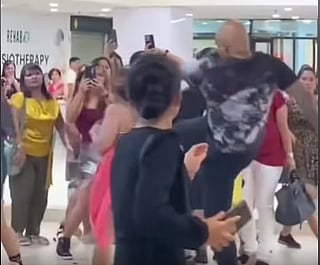 Screenshot from the viral video of a Filipina OFW assaulted by a foreigner in Singapore