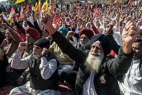 Farmers and trade union workers shout slogans during a nationwide strike over government policies and other issues in Amritsar on February 12, 2026.