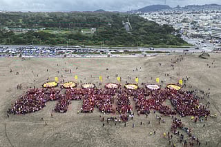 Hundreds of San Francisco teachers form a human banner spelling "STRIKE" on Ocean Beach on the third day of a district-wide strike over wages, benefits and other issues.