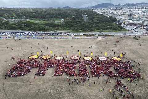 Hundreds of San Francisco teachers form a human banner spelling "STRIKE" on Ocean Beach on the third day of a district-wide strike over wages, benefits and other issues.