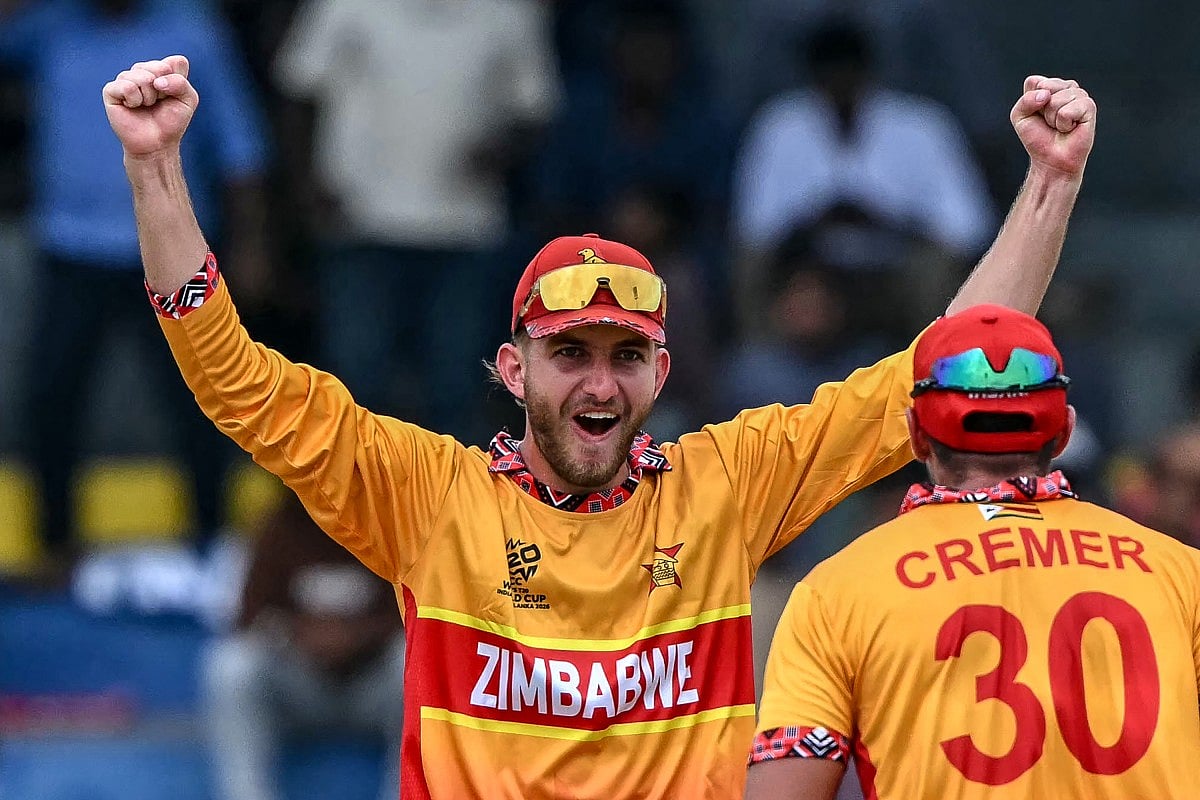 Zimbabwe's Brian Bennett (L) celebrates with teammate Graeme Cremer after their team's win in the 2026 ICC Men's T20 Cricket World Cup group stage match between Australia and Zimbabwe at the R Premadasa Stadium in Colombo on February 13, 2026.