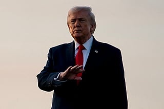 President Donald Trump gestures to members of the media after exiting Air Force One at Palm Beach International Airport on February 13, 2026 in West Palm Beach, Florida.