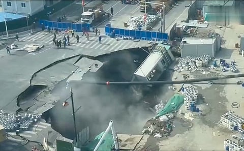 The massive sinkhole swallowed the intersection of Qixin Road and Li'an Road in Shanghai's Minhang District on the morning of February 12, 2026, as reported by local media. 