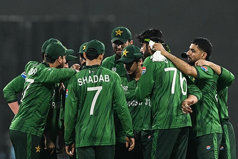 Pakistan's team player gather at the end of the first innings during the 2026 ICC Men's T20 Cricket World Cup group stage match between India and Pakistan at the R Premadasa Stadium in Colombo on February 15, 2026.