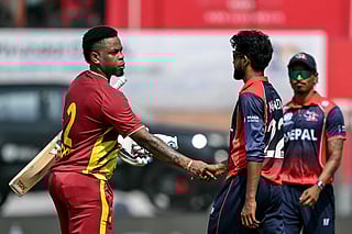 West Indies' Shimron Hetmyer (L) shakes hands with Nepal's Nandan Yadav at the end of the 2026 ICC Men's T20 Cricket World Cup group stage match between Nepal and West Indies at the Wankhede Stadium in Mumbai on February 15, 2026.