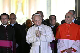 Pope Leo XIV speaks next to Italian cardinal Baldassare Reina at the end of a mass during a pastoral visit to the parish of “St. Mary Queen of Peace" at Ostia Lido, near Rome, on February 15, 2026.