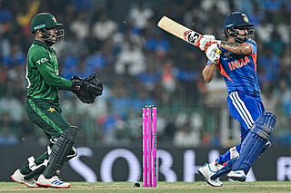 India's Ishan Kishan (R) plays a shot as Pakistan's wicketkeeper Usman Khan reacts during the 2026 ICC Men's T20 Cricket World Cup group stage match between India and Pakistan at the R Premadasa Stadium in Colombo on February 15, 2026.