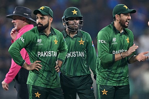 Pakistan's captain Salman Agha (R) celebrates with teammates after the dismissal of India's Hardik Pandya.