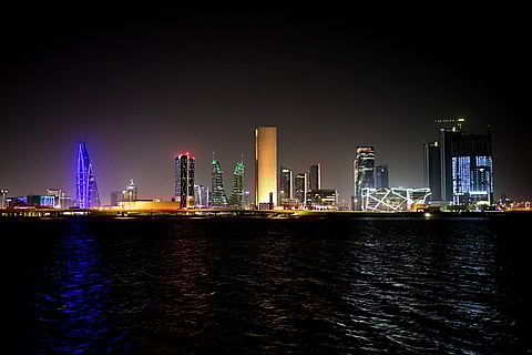 A picture taken on February 16, 2026, shows the skyline of the Bahraini capital Manama at night.