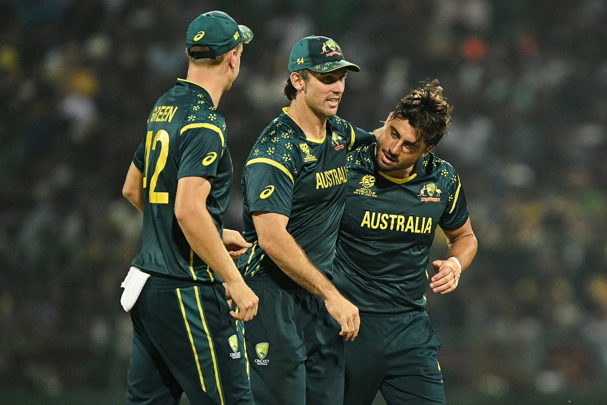 Australia's Marcus Stoinis (R) celebrates with captain Mitchell Marsh (C) and Cameron Green after taking the wicket of Sri Lanka's Kusal Mendis during the 2026 ICC Men's T20 Cricket World Cup group stage match between Australia and Sri Lanka at Pallekele International Cricket Stadium in Kandy on February 16, 2026.