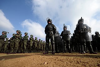 Guatemalan soldiers and police officers stand in formation during the inauguration of the Sentinel Plan which seeks to provide security in the metropolitan area to curb extortion and assaults and neutralize gang operations, in the Alamedas neighborhood in Guatemala City on February 17, 2026.