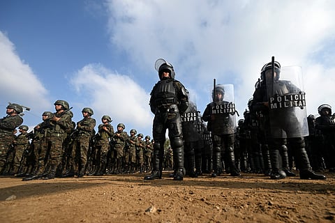 Guatemalan soldiers and police officers stand in formation during the inauguration of the Sentinel Plan which seeks to provide security in the metropolitan area to curb extortion and assaults and neutralize gang operations, in the Alamedas neighborhood in Guatemala City on February 17, 2026.