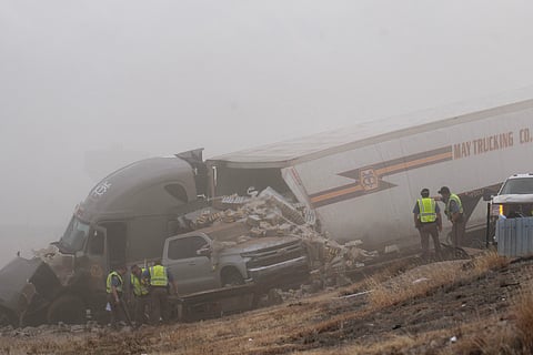 Emergency personnel work the scene of a crash involving 30-plus vehicles including six semi trucks on Interstate 25 south of Pueblo, Colo., on Tuesday, Feb. 17, 2026.  