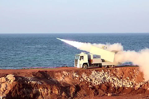 This handout photo released by Iran's Revolutionary Guards Corps (IRGC)'s official website Sepanews on February 16, 2026, shows a vehicle firing a missile during a military exercise by members of the IRGC and navy in the Gulf.  