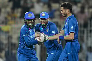 Afghanistan's Abdollah Ahmadzai (R) celebrates with teammates after taking a catch to dismiss Canada's Dilon Heyliger during the 2026 ICC Men's T20 Cricket World Cup group stage match between Afghanistan and Canada at the MA Chidambaram Stadium in Chennai on February 19, 2026.