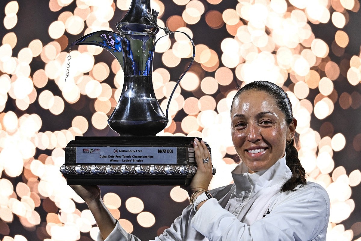 US' Jessica Pegula celebrates with the trophy after winning her women’s singles final match against Ukraine's Elina Svitolina at the Dubai Duty Free Tennis tournament in Dubai on February 21, 2026.
