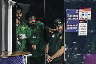 Pakistan's Babar Azam (C) and his captain Salman Agha (L) react after the 2026 ICC Men's T20 Cricket World Cup Super Eight match between Pakistan and New Zealand was called off due to rain at the R Premadasa Stadium in Colombo on February 21, 2026.