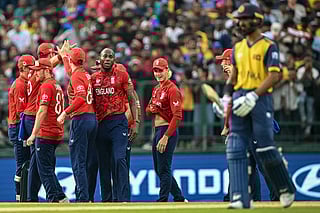 England's Jofra Archer (center L) celebrates with teammates after taking the wicket of Sri Lanka's Kamil Mishara during the 2026 ICC Men's T20 Cricket World Cup Super Eights match between Sri Lanka and England at Pallekele International Cricket Stadium in Kandy on February 22, 2026.