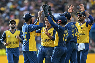 Sri Lanka's Dunith Wellalage (C) celebrates with teammates after taking the wicket of England's Phil Salt during the 2026 ICC Men's T20 Cricket World Cup Super Eights match between Sri Lanka and England at Pallekele International Cricket Stadium in Kandy on February 22, 2026.