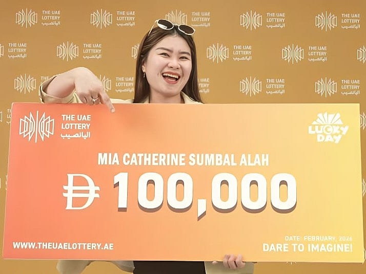 A life-changing first try: Mia Catherine Sumbal Alah proudly displays her Dh100,000 winnings from the UAE Lottery draw.