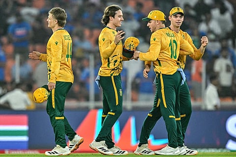 South Africa's players celebrate after their team's win in the 2026 ICC Men's T20 Cricket World Cup Super Eights match between India and South Africa at the Narendra Modi Stadium in Ahmedabad on February 22, 2026.