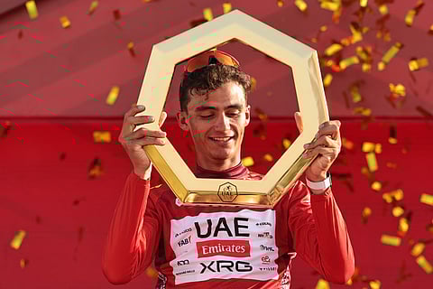 Championship first place winner UAE Team Emirates's Mexican rider Isaac Del Toro Romero celebrates on the podium after the seventh and final stage of the UAE Tour cycling event from Zayed National Museum to Abu Dhabi Breakwater in Abu Dhabi on February 22, 2026.